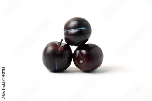 Black cherry plums isolated on white background