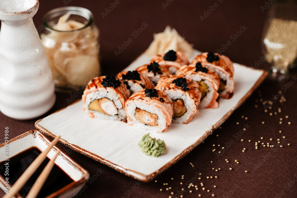Sushi set with black caviar and eel, poured with soy sauce and Sushi set with black caviar and eel, poured with soy sauce and