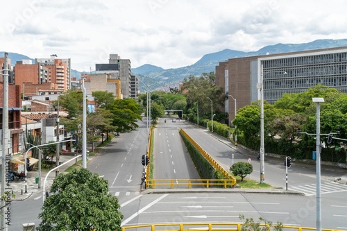 Medellin, Antioquia, Colombia. July 20, 2020: Urban landscape on Nutibara avenue with sky and mountains. Quarantine in the city. photo