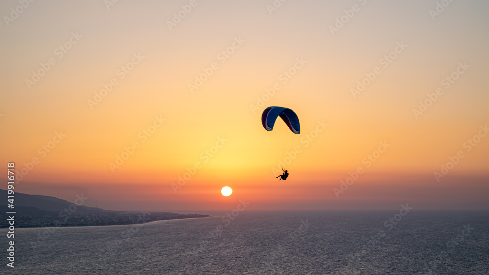 Parachuting - Paragliding in sunset Parachuting - Paragliding in sunset