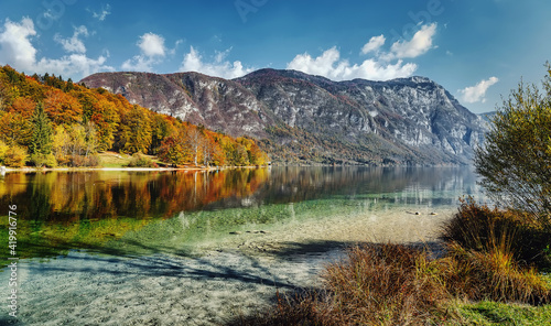 Beautiful nature landscape view on Bohinj Lake, with turquoise water and mountains on background. Bohinj Lake, Triglav National Park, Julian Alps, Slovenia. Concept of ideal resting place.