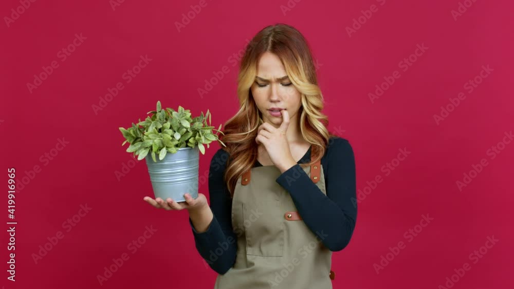 Young blonde girl holding a plant having doubts and questioning an idea over isolated background Young blonde girl holding a plant having doubts and questioning an idea over isolated background