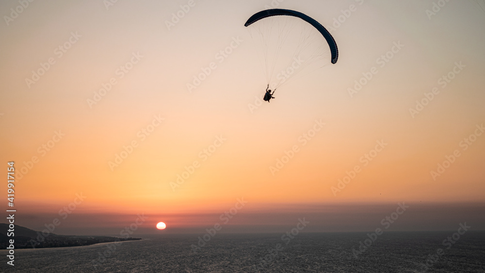 Parachuting - Paragliding in sunset