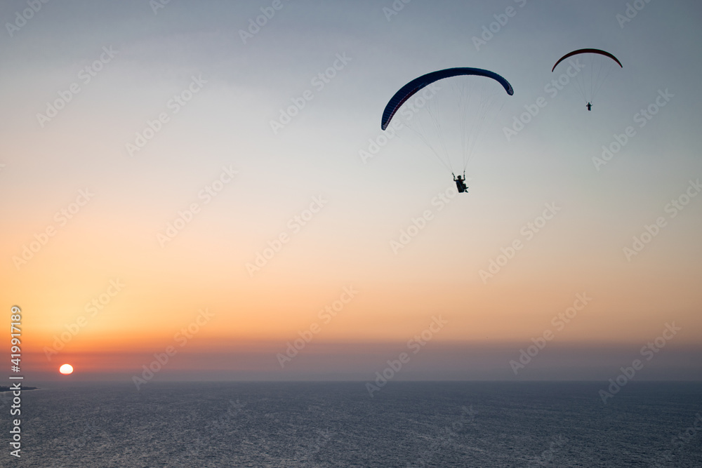 Parachuting - Paragliding in sunset