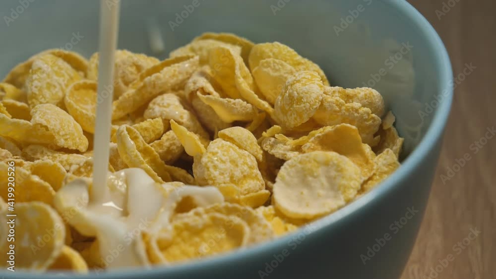 Milk Pouring into a Bowl of Cereal Splashing in Slow Motion Shot at 180 fps.healthy cereal breakfast Milk Pouring into a Bowl of Cereal Splashing in Slow Motion Shot at 180 fps.healthy cereal breakfast