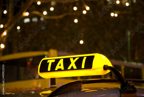 german yellow taxi sign at night with lights