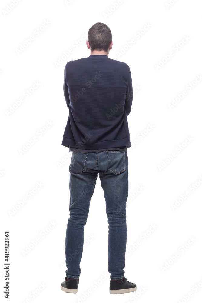 rear view. a young man in jeans and a jacket . rear view. a young man in jeans and a jacket .