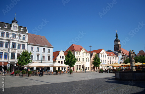 cottbus alttmarkt, germany, with historic well and cafe