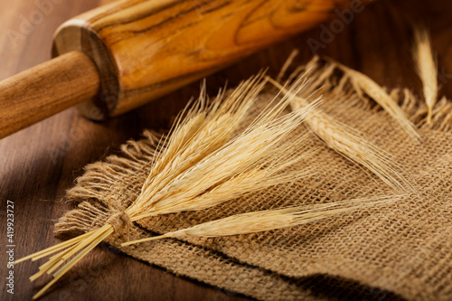 Ears of wheat on wooden background.