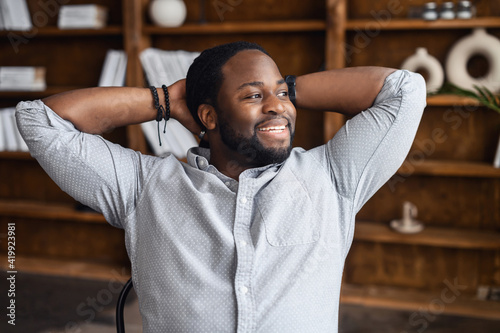 Canvas Print Carefree and successful African-American businessman taking a break on the workp
