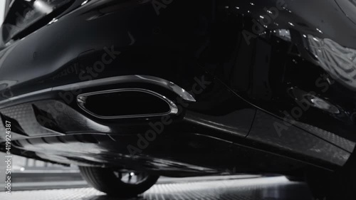 Wallpaper Mural Closeup of a chrome exhaust pipe of a new car in a dealer showroom. 4K shot.	
 Torontodigital.ca