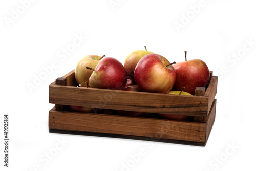 Fresh apples in a wooden crate isolated on white background