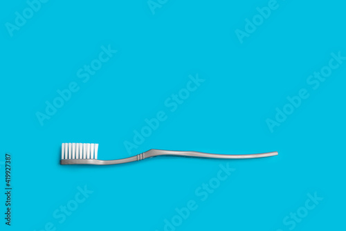 one gray toothbrush on a blue background copy the space. the concept of oral hygiene, dental care