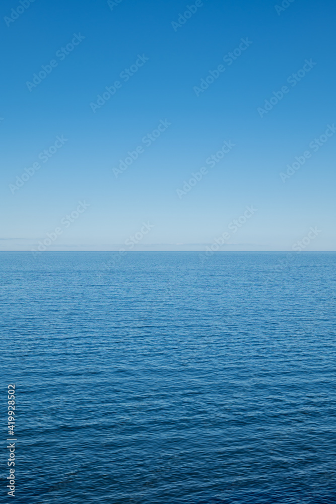 The Baltic Sea on a sunny day with horizon and blue sky.