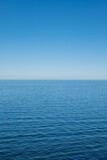 The Baltic Sea on a sunny day with horizon and blue sky.