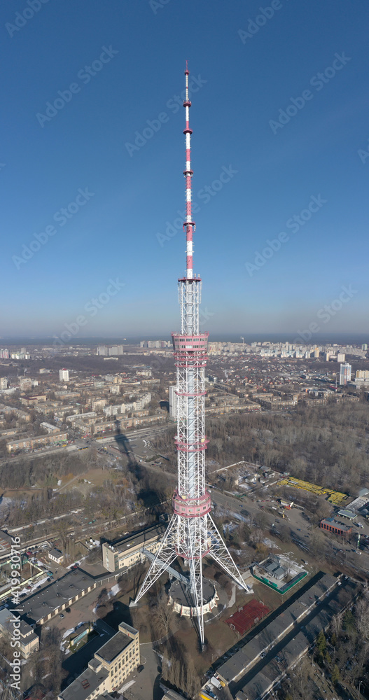Obraz premium telecommunication tower with many transmitters and receivers for various radio frequencies and data transmission, including 5G and satellite at blue sky