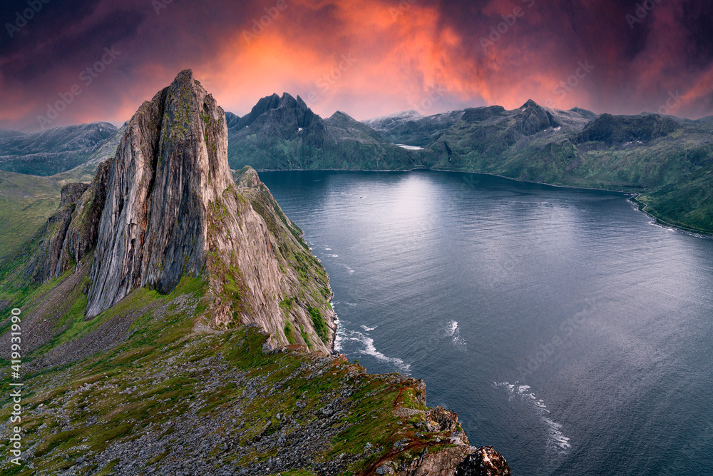 Segla Mountain from a nearby peak during sunset. The sky turned bright red orange and purple to give this image a dramatic variation to typical Norwegian landscapes. Heston Hike