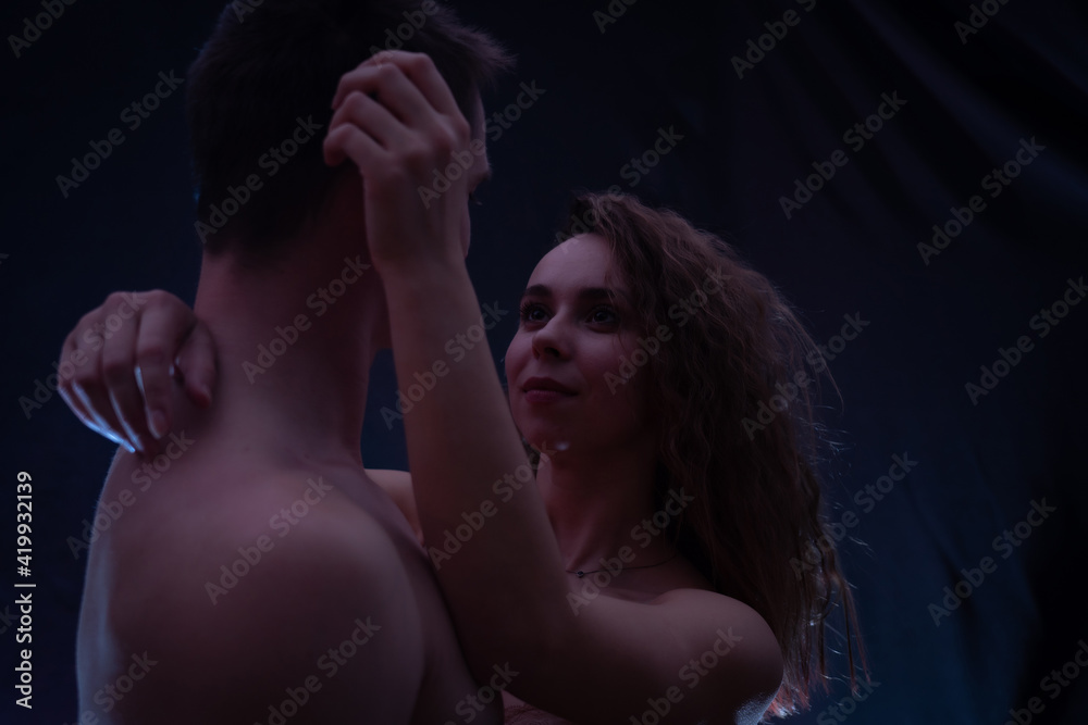 muscular handsome sexy guy with pretty woman, on dark background. concept of romantic, love and feelings muscular handsome sexy guy with pretty woman, on dark background. concept of romantic, love and feelings