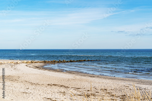 a ridge of stones go to the baltic sea on a sandy beach