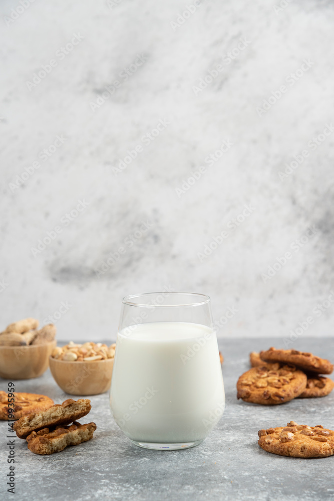 Cookies with organic peanuts and honey with glass of milk on marble background Cookies with organic peanuts and honey with glass of milk on marble background
