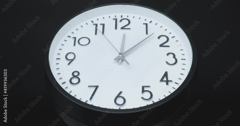 Clock running fast. Clock Time Lapse on black background. Video symbolizing fast flies of time.