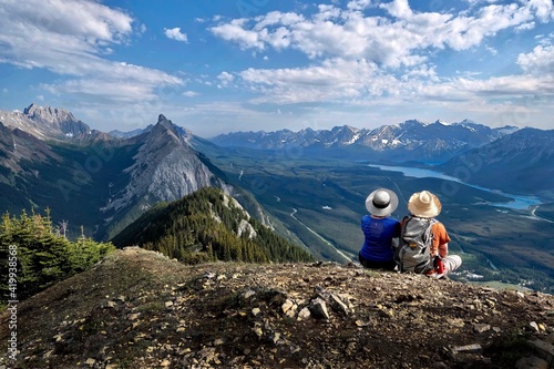 Canvas Print Adventurous couple on mountain top looking at scenic view
