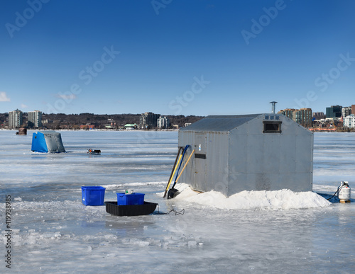 Ice fishing cabin and tents on frozen Kempenfelt Bay of Lake Simcoe at Barrie Canada in winter photo