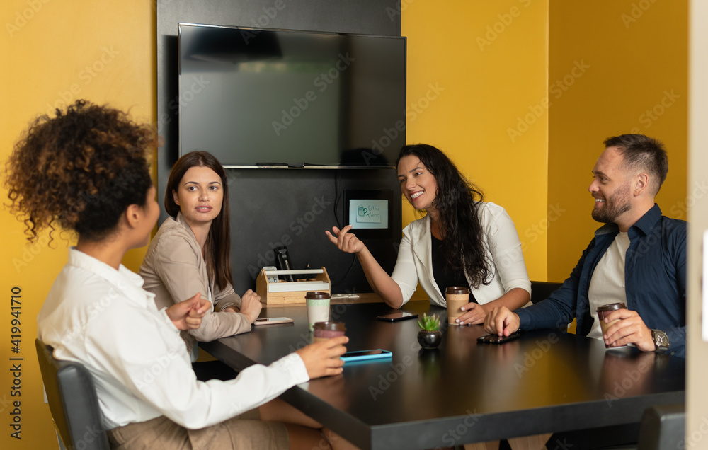 brazilian woman talking with co-workers . brazilian woman talking with co-workers .