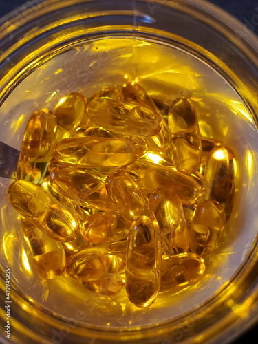 Top view of cod liver oil pills inside glass jar