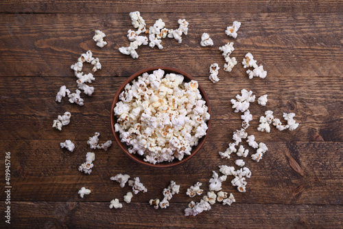 Popcorn in bowl on a red background. Close up. Top view