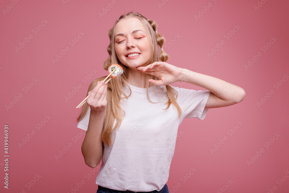 Happy woman with Sushi on a pink background Happy woman with Sushi on a pink background