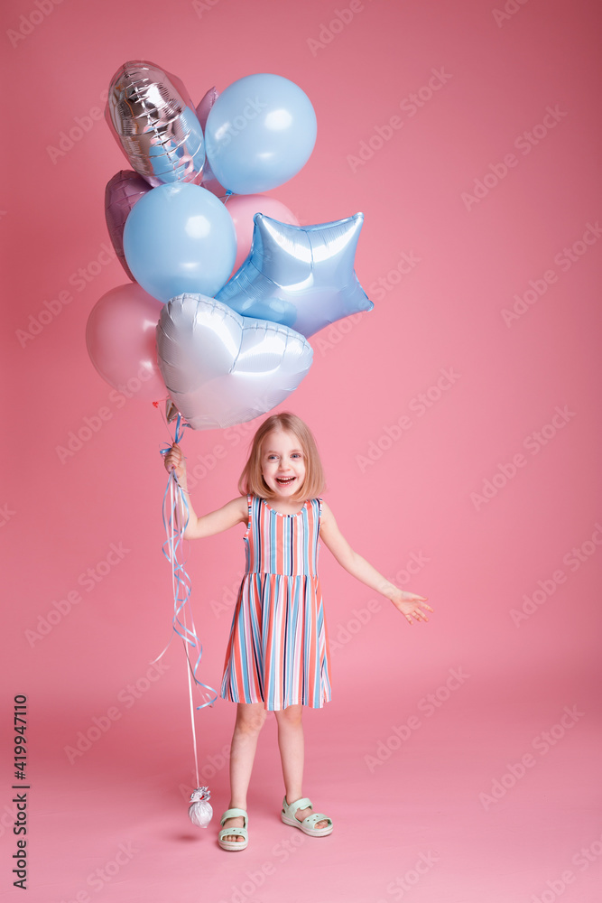 A little girl with balloons playing. Children's Day