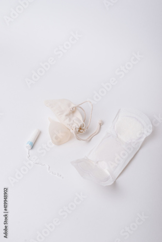 Photo of tampon, menstrual cup.Concept of critical days, menstruation, over white background
