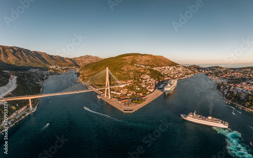 Aerial drone shot of Lapad Gruz peninsula area with Dubrovnik bridge cruise ship in Croatia summer sunset photo