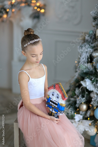 A small ballerina near the Christmas tree. The Nutcracker . New Year's gifts