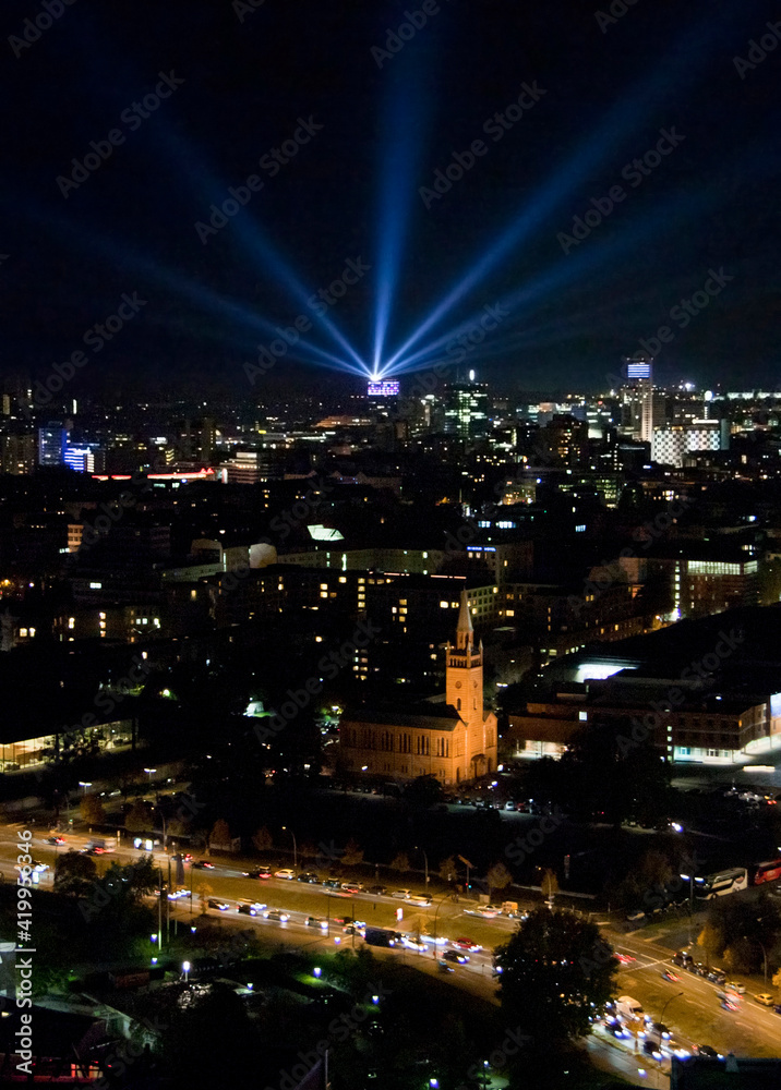 Skyline of Berlin at Night with Laser Sky