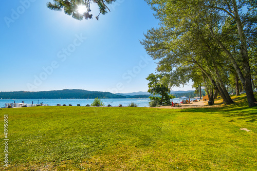 Tourists and local Idahoans enjoy a summer afternoon at the City Beach and Park along Lake Coeur d'Alene, in the Inland Northwest of the US. photo