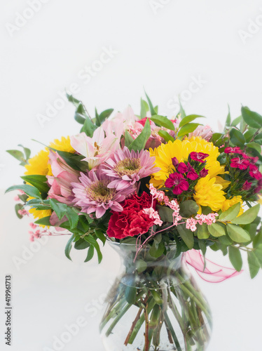Colorful spring flowers bouquet in a vase on white background. Spring flower bouquet bundles with space for celebration concept text.