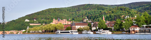 Panoramic view of Heidelberg town in Germany in springtime. Passenger ships moored by the promenade. Panoramic banner image. photo