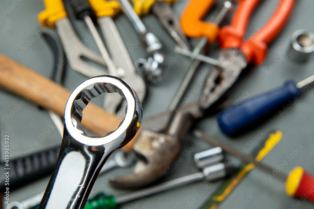 Fototapeta premium Streak wrench isolated on blurred background with a variety of tools