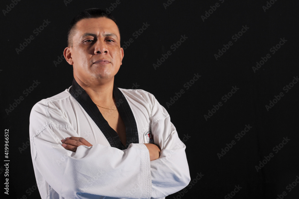 Latin taekwondo teacher with cross hands Latin taekwondo teacher with cross hands