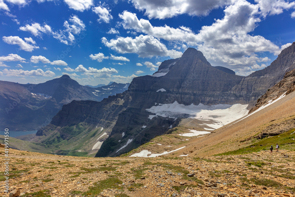Hiking down the Baring Creek Trail from Siyeh Pass with Sexton Glacier in view in Glacier National Park, Montana, USA