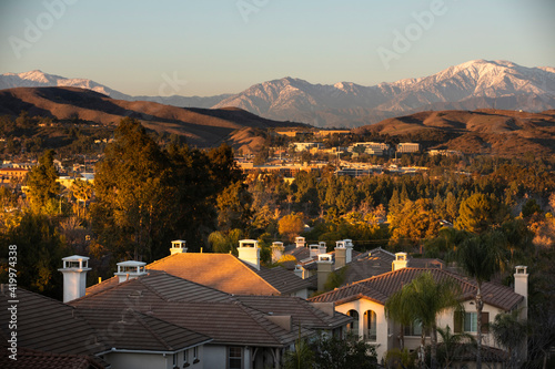 Snow capped mountain sunset view of the downtown area of Brea, California, USA.  photo