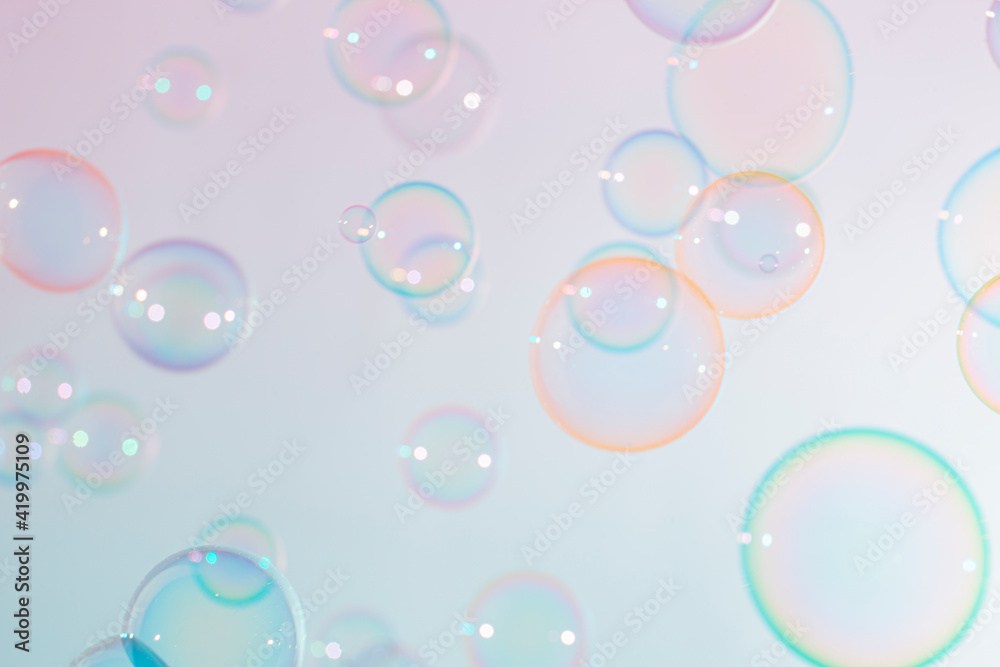 Beautiful blur transparent colorful soap bubbles floating background.	