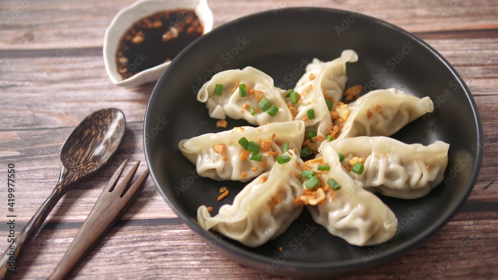 Steamed Gyoza or dumpling stuffed ground pork dipping with garlic soy sauce Steamed Gyoza or dumpling stuffed ground pork dipping with garlic soy sauce