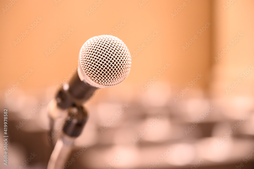 Microphone over the blurred business people forum Meeting Conference Training Learning Coaching Concept, Blurred background. Microphone over the blurred business people forum Meeting Conference Training Learning Coaching Concept, Blurred background.