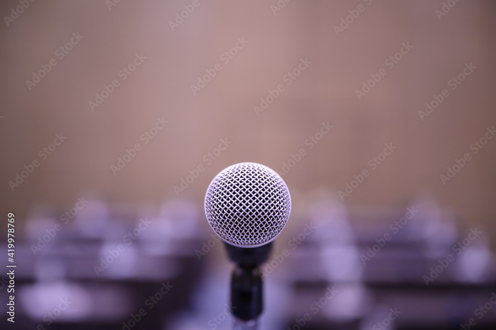 Microphone over the blurred business people forum Meeting Conference Training Learning Coaching Concept, Blurred background. Microphone over the blurred business people forum Meeting Conference Training Learning Coaching Concept, Blurred background.