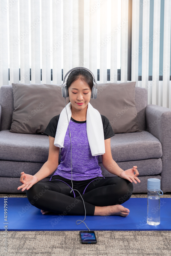 Young beautiful asian women wearing fashion sports wear doing exercise on mat indoor training at home, Sport and recreation concept Young beautiful asian women wearing fashion sports wear doing exercise on mat indoor training at home, Sport and recreation concept