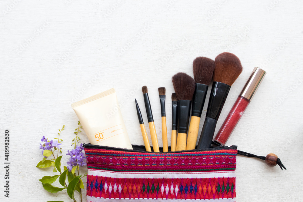 Naklejka premium sunscreen spf50,brush,lipstick and colorful bag set cosmetics beauty makeup of lifestyle woman arrangement flat lay style on background white