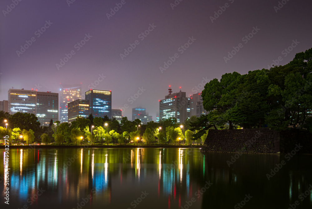 City park near Imperial Palace in Tokyo at a rainy night in Japan.